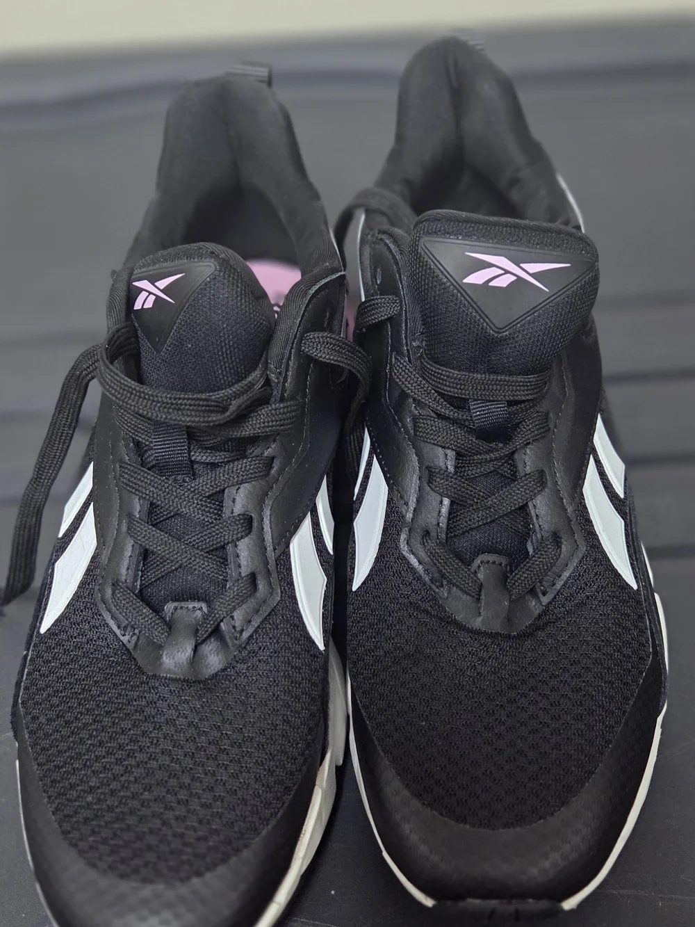 Reebok Black Athletic Sneakers with White Stripes and Pink Logo